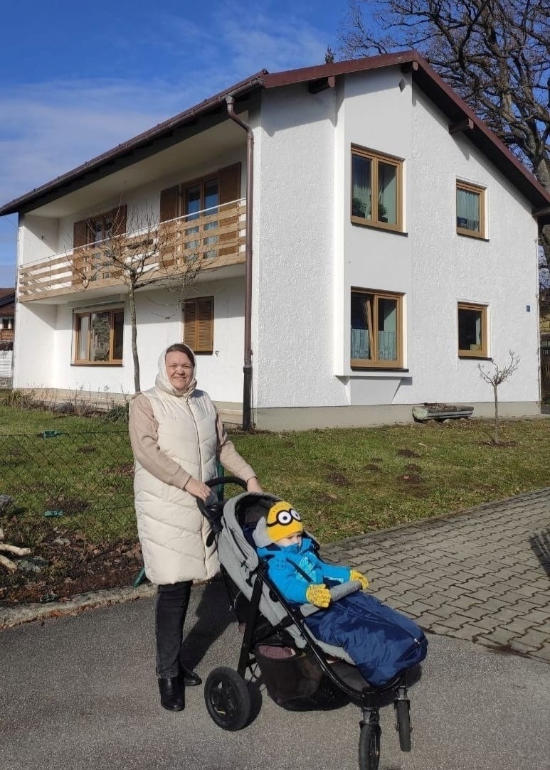Iryna with her grandson near their house in Germany